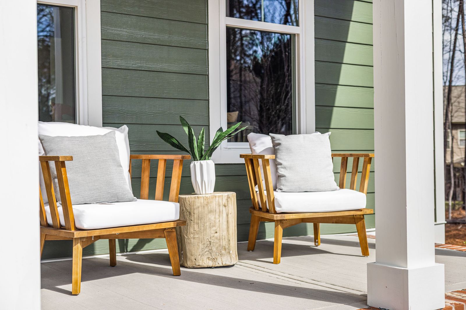 Green James Hardie fiber cement lap siding on a covered porch