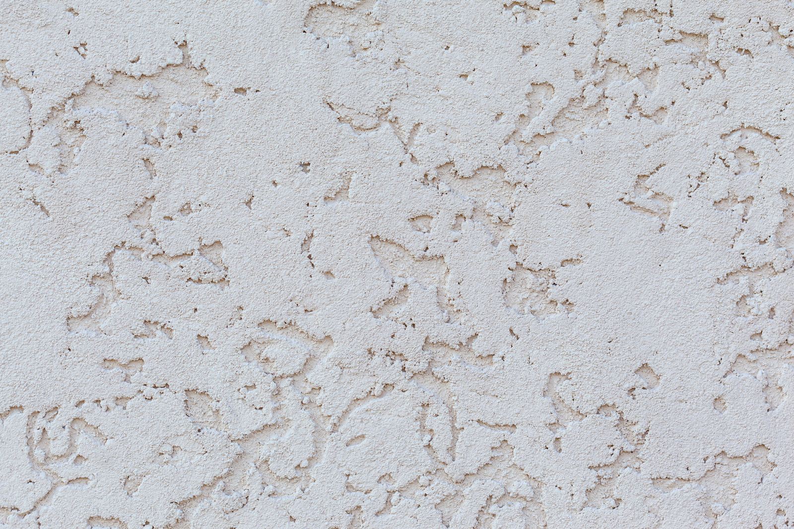 Close-up of stucco wall surface showing texture and hairline detail